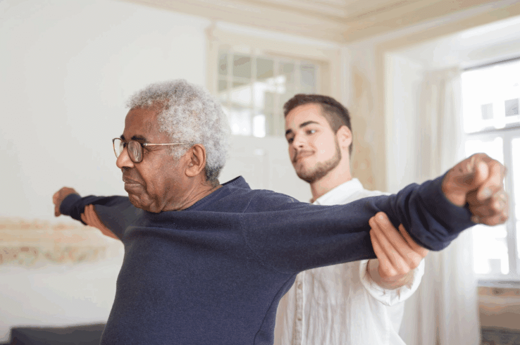 A physical therapist helping a senior stretch