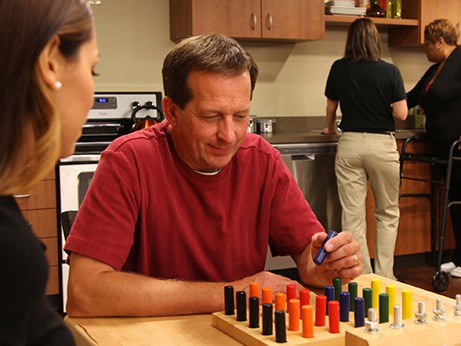 A man plays a game for occupational therapy