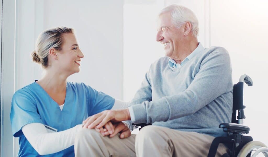 A healthcare center nurse with a senior man in wheelchair