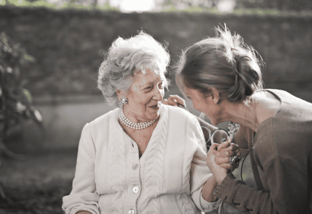 Senior citizen holding hands with a younger adult
