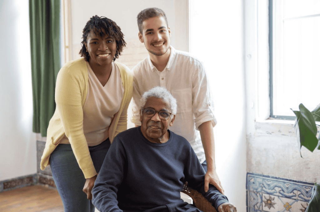 Senior with two young adults