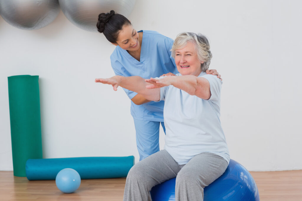 senior woman doing physical therapy exercises with skilled nursing staff member.